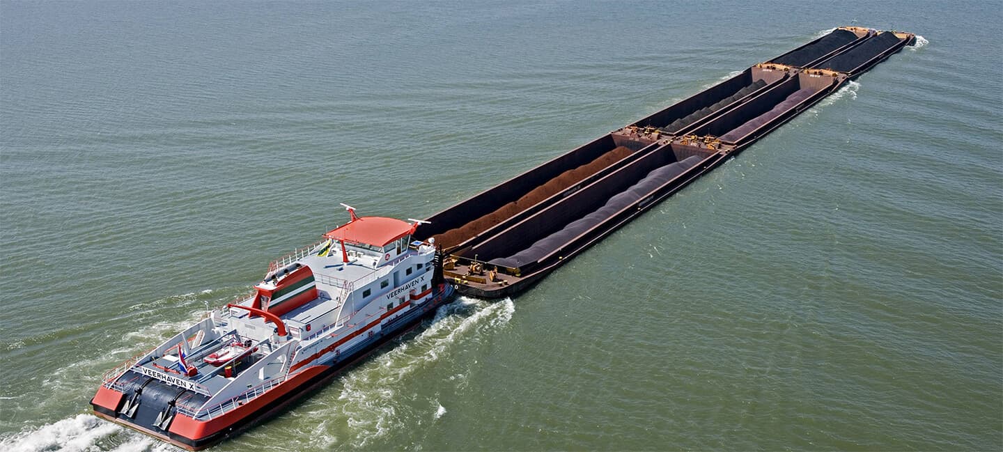 Push boat with loaded barges on open water